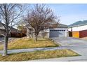 Well-maintained single-Gathering home with a paved driveway and mature landscaping at 16351 E 104Th Pl, Commerce City, CO 80022
