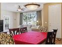 Inviting living and dining area featuring a view to the outside and neutral interior design at 9896 W Freiburg Dr # 1B, Littleton, CO 80127