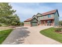 Two-story home featuring a spacious driveway, attached garage, and a well-maintained lawn at 23427 Song Bird Hills Pl, Parker, CO 80138