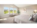 Serene main bedroom featuring large windows with scenic views, neutral colors, and comfortable seating at 14284 W 88Th Dr # B, Arvada, CO 80005