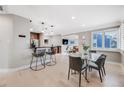 Bright, open-concept dining room with modern table, chairs, and seamless flow to the kitchen at 2424 S Humboldt St, Denver, CO 80210