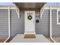 Close-up of the front door with a wreath, showcasing the home's address and a 'hello' doormat at 2424 S Humboldt St, Denver, CO 80210