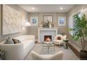 Bright living room featuring a fireplace, stylish decor, modern furniture, neutral paint, and hardwood floors at 285 E Dartmouth Ave, Englewood, CO 80113