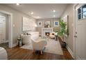 Inviting living room featuring a cozy fireplace, hardwood floors, and stylish, neutral furnishings at 285 E Dartmouth Ave, Englewood, CO 80113