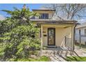 Charming home with a cozy front porch and well-maintained yard with mature landscaping at 3064 S Cherokee St, Englewood, CO 80110
