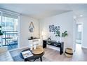 Bright living room with modern decor, balcony access and light hardwood flooring at 830 N Sherman St # 205, Denver, CO 80203