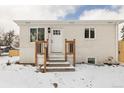 Charming front entrance featuring a stylish door, white brick, and steps with wooden railings at 2293 S Sherman St, Denver, CO 80210