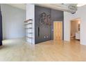 Stylish living room boasts hardwood floors, industrial ductwork, and wall-mounted bike rack, perfect for urban living at 3100 Huron St # 4N, Denver, CO 80202
