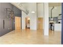 Bright living room with hardwood floors, industrial ductwork, and access to kitchen and bathroom at 3100 Huron St # 4N, Denver, CO 80202