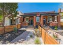 Charming brick duplex with inviting curb appeal and landscaped front yard, perfect for city living at 3329 N High St, Denver, CO 80205