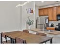 Eat in Kitchen featuring stainless steel appliances and pendant lighting at 4100 Albion St # 424, Denver, CO 80216