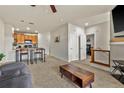 Open-concept living room featuring a breakfast bar and view of the stairway at 4100 Albion St # 424, Denver, CO 80216