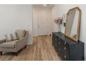 Bright entryway with stylish dresser and comfortable armchair at 27728 E 10Th Dr, Aurora, CO 80018