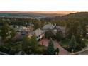 An elegant home with stone accents, meticulous landscaping, and a basketball hoop in the driveway at 5085 Knobcone Dr, Castle Rock, CO 80108