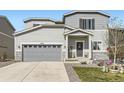 Charming two-story home with a gray exterior, landscaped front yard, and a two-car garage at 4746 River Highlands Loop, Elizabeth, CO 80107