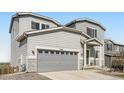 Charming two-story home with a gray exterior, stone accents, and a two-car garage at 4746 River Highlands Loop, Elizabeth, CO 80107