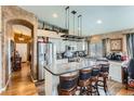 A gourmet kitchen with stainless steel appliances, a center island, and wood flooring at 815 Concho Ct, Castle Rock, CO 80104