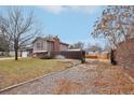 Exterior view of the home showcasing a gravel driveway and side yard at 327 S 29Th Ave, Brighton, CO 80601