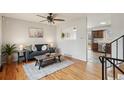 Bright living room with hardwood floors and a view into the kitchen at 327 S 29Th Ave, Brighton, CO 80601