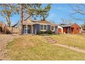 Inviting home exterior featuring a covered front porch and stone walkway at 4441 Elm Ct, Denver, CO 80211