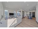 Open concept living room with hardwood floors and lots of natural light at 6047 N Nepal Ct, Aurora, CO 80019