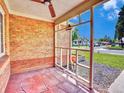 Cozy covered porch with a ceiling fan and views of the street and neighboring houses at 1600 Xanthia St, Denver, CO 80220