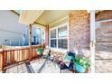 Inviting front porch featuring chairs and a side table, creating an inviting outdoor space at 12861 Royal Ct, Broomfield, CO 80020