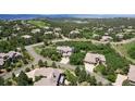 An aerial view of a neighborhood full of well maintained homes surrounded by lush green trees at 6299 Ellingwood Point Pl, Castle Rock, CO 80108