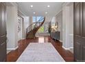 Elegant foyer featuring a curved staircase, hardwood floors, and ample natural light at 6299 Ellingwood Point Pl, Castle Rock, CO 80108