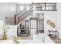 Inviting foyer with a grand staircase, high ceilings, and natural light, creating a welcoming entrance at 27500 E Lakeview Dr, Aurora, CO 80016