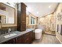 Modern bathroom with a soaking tub, walk-in shower, double vanity, and contemporary fixtures, creating a spa-like experience at 6480 Moss Cir, Arvada, CO 80007