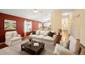 Comfortable living room showcases vaulted ceilings, modern furnishings, and hardwood flooring at 6480 Moss Cir, Arvada, CO 80007