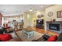 Cozy living room with a fireplace, hardwood floors, and an open layout, perfect for relaxing with friends and Gathering at 6480 Moss Cir, Arvada, CO 80007
