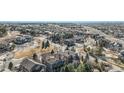 Wide aerial view of a neighborhood featuring mature landscaping and curved streets at 24273 E Fremont Dr, Aurora, CO 80016