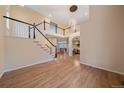 Open foyer with hardwood floors and views of the living and dining areas at 6393 S Richfield St, Aurora, CO 80016