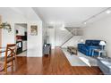 Spacious living room with hardwood floors, bright staircase, and open layout at 8738 Chase Dr # 133, Arvada, CO 80003