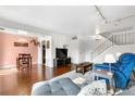 Bright living room featuring stylish furnishings, hardwood floors, and an open staircase at 8738 Chase Dr # 133, Arvada, CO 80003