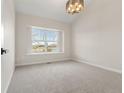 Bright bedroom featuring plush carpet, neutral walls, and a large window at 19417 E Purdue Cir, Aurora, CO 80013