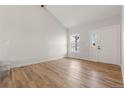Bright living room with wood-look flooring and a vaulted ceiling at 19417 E Purdue Cir, Aurora, CO 80013