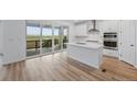 Modern kitchen with white cabinets, stainless steel appliances, and a large island at 8840 Whiteclover St, Littleton, CO 80125