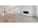 Spacious living room with hardwood floors, fireplace, and ample natural light at 8840 Whiteclover St, Littleton, CO 80125