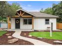 Home exterior showcasing a modern design, inviting entrance, and beautifully landscaped front yard at 3287 S Humboldt St, Englewood, CO 80113