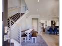 Light-filled entryway with modern staircase, dining area, and an open view of the kitchen at 3003 S Sherman St, Englewood, CO 80113