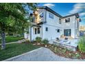 Well-maintained backyard featuring a patio with fire pit, lush green lawn, and beautiful landscaping at 2182 S Ogden St, Denver, CO 80210