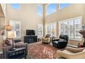 Spacious living room featuring a fireplace and ample natural light at 3953 Blue Pine Cir, Highlands Ranch, CO 80126