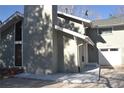 Residential exterior featuring a large chimney, single-car garage, and neutral siding at 9551 E Chenango Ave, Greenwood Village, CO 80111