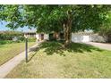 Charming single-Gathering home featuring a well-manicured lawn and mature trees providing ample shade at 291 Magnolia St, Denver, CO 80220