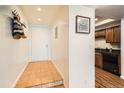 Bright entryway leads to the kitchen with modern appliances and ample cabinet space at 701 Harlan St # E59, Lakewood, CO 80214