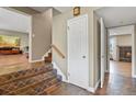 Inviting entryway featuring decorative tile stairs and floors with an open view into other living spaces at 7376 S Jackson St, Centennial, CO 80122