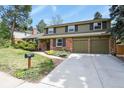 Charming two-story home with brick and siding exterior, a well-manicured lawn, and an attached two-car garage at 7376 S Jackson St, Centennial, CO 80122
